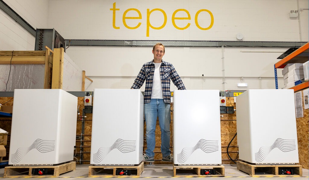 Johan Du Plessis standing with a row of tepeo's Zero Emission boilers.