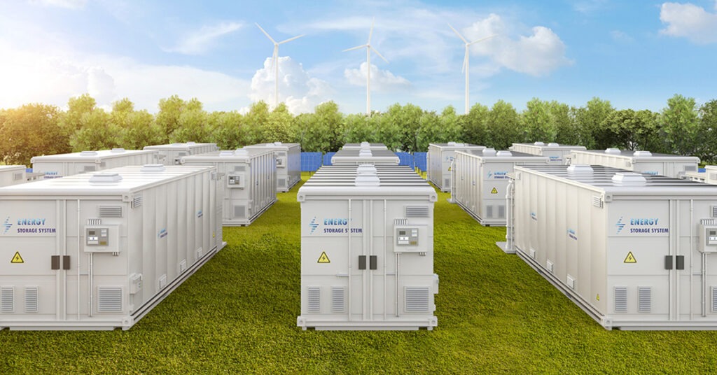 Energy storage units with solar panels and wind turbines in the background